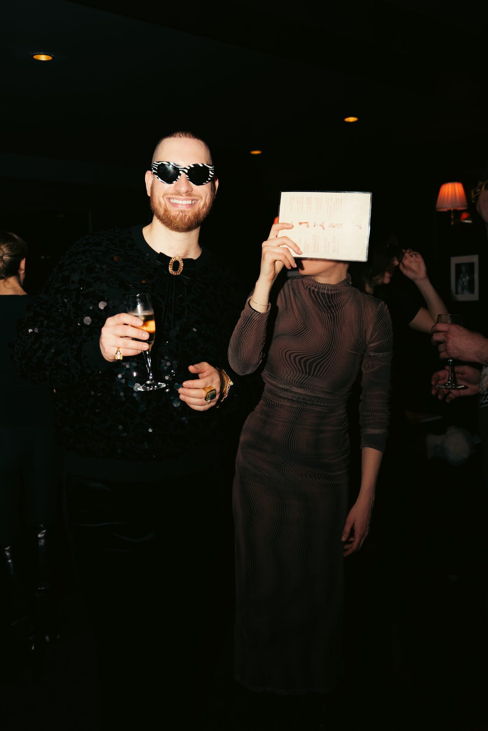 Guests toasting with champagne during a night at La Perla