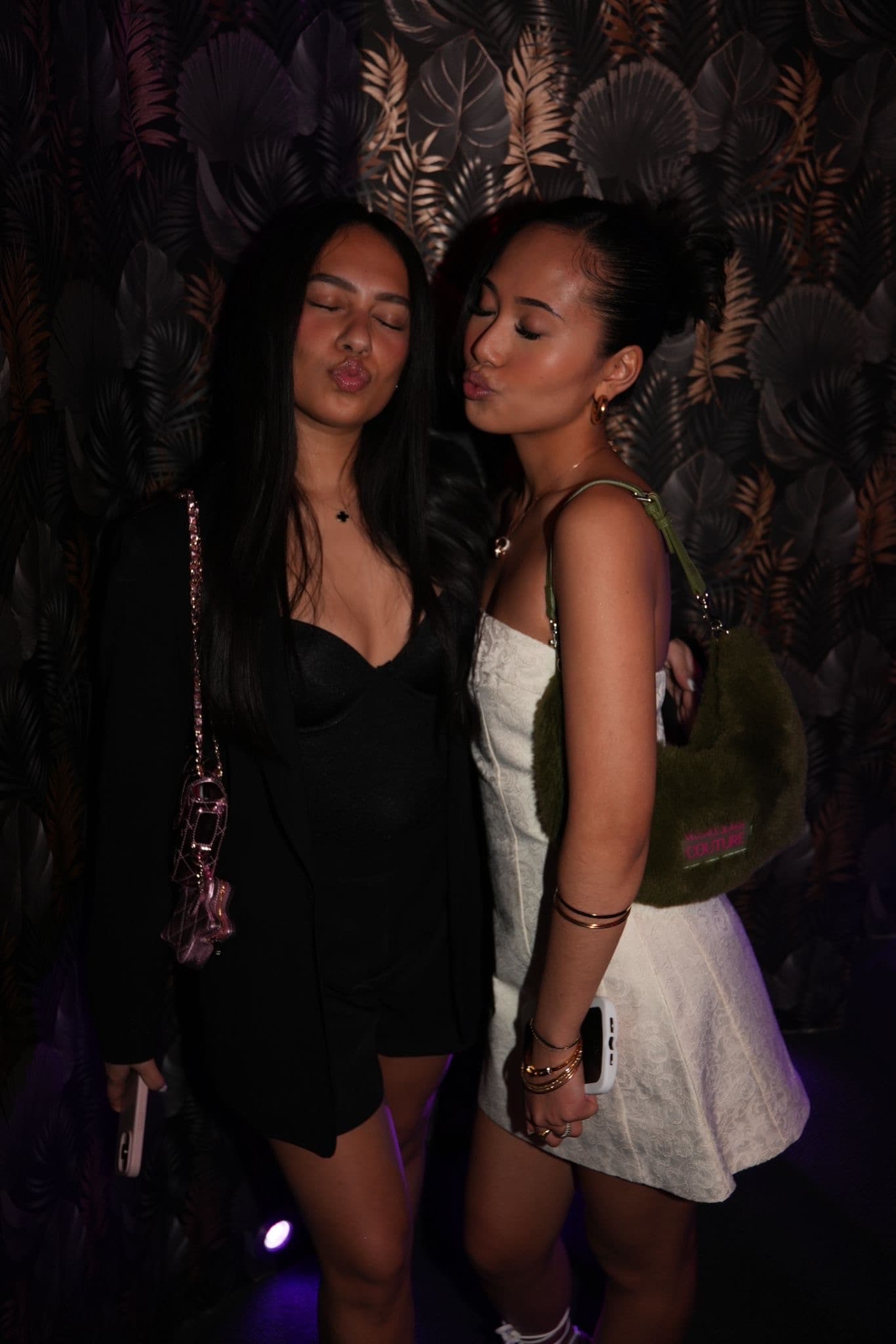 Two guests posing during a Latin club night at La Perla