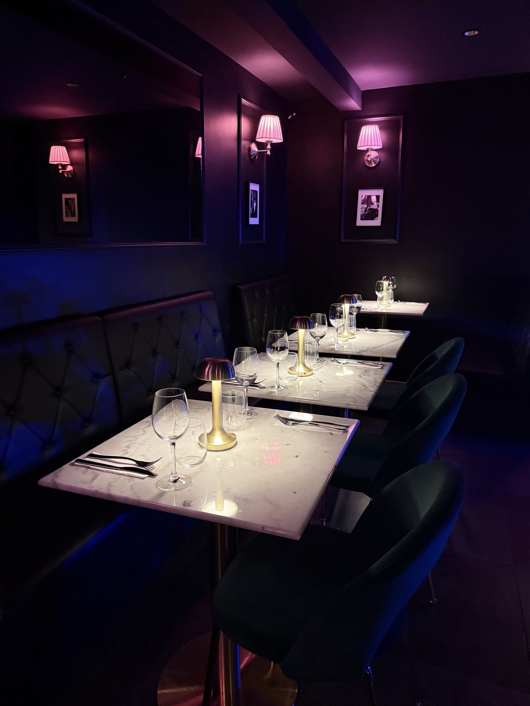 Dining room from above, marble tables set at La Perla Paris
